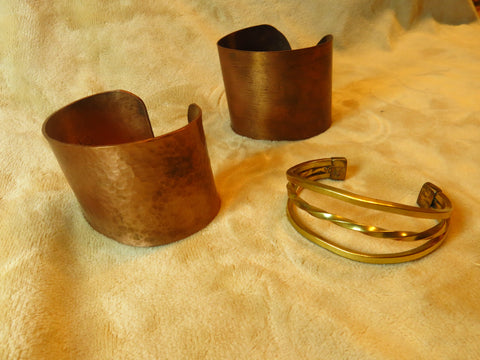 2 wide copper cuffs and one triple wire brass cuff